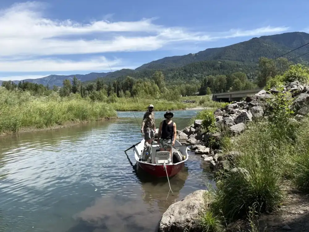 Fishing guide boat with clients on Bow River