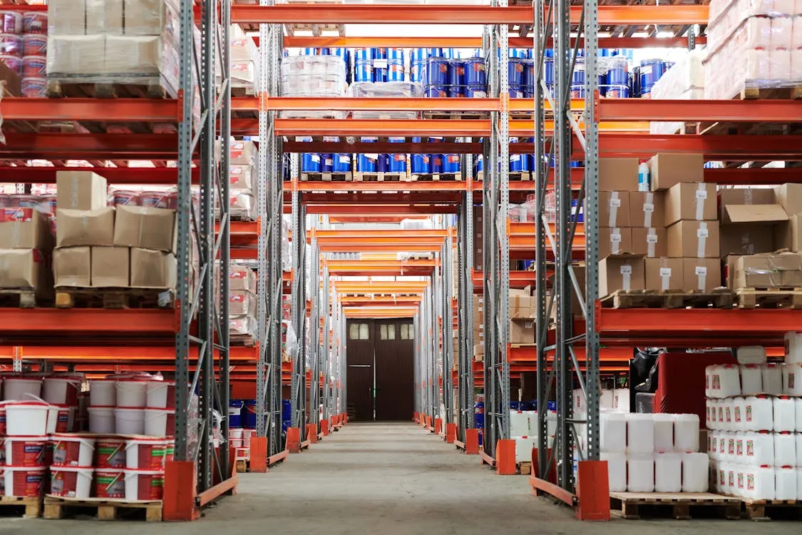 E-commerce fulfillment center with organized product shelves and shipping stations for online orders