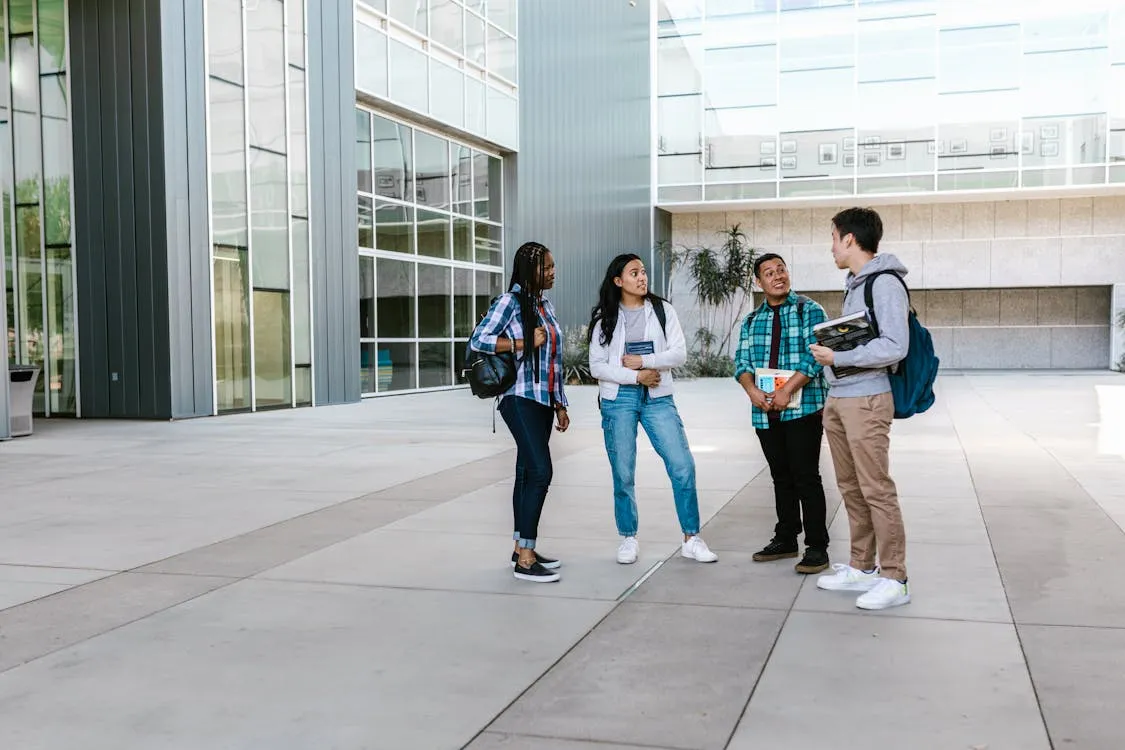 Modern school campus with students using digital devices for learning and research