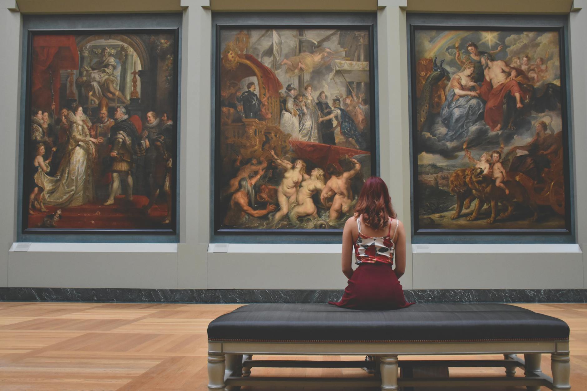 Art gallery wall with paintings and warm lighting