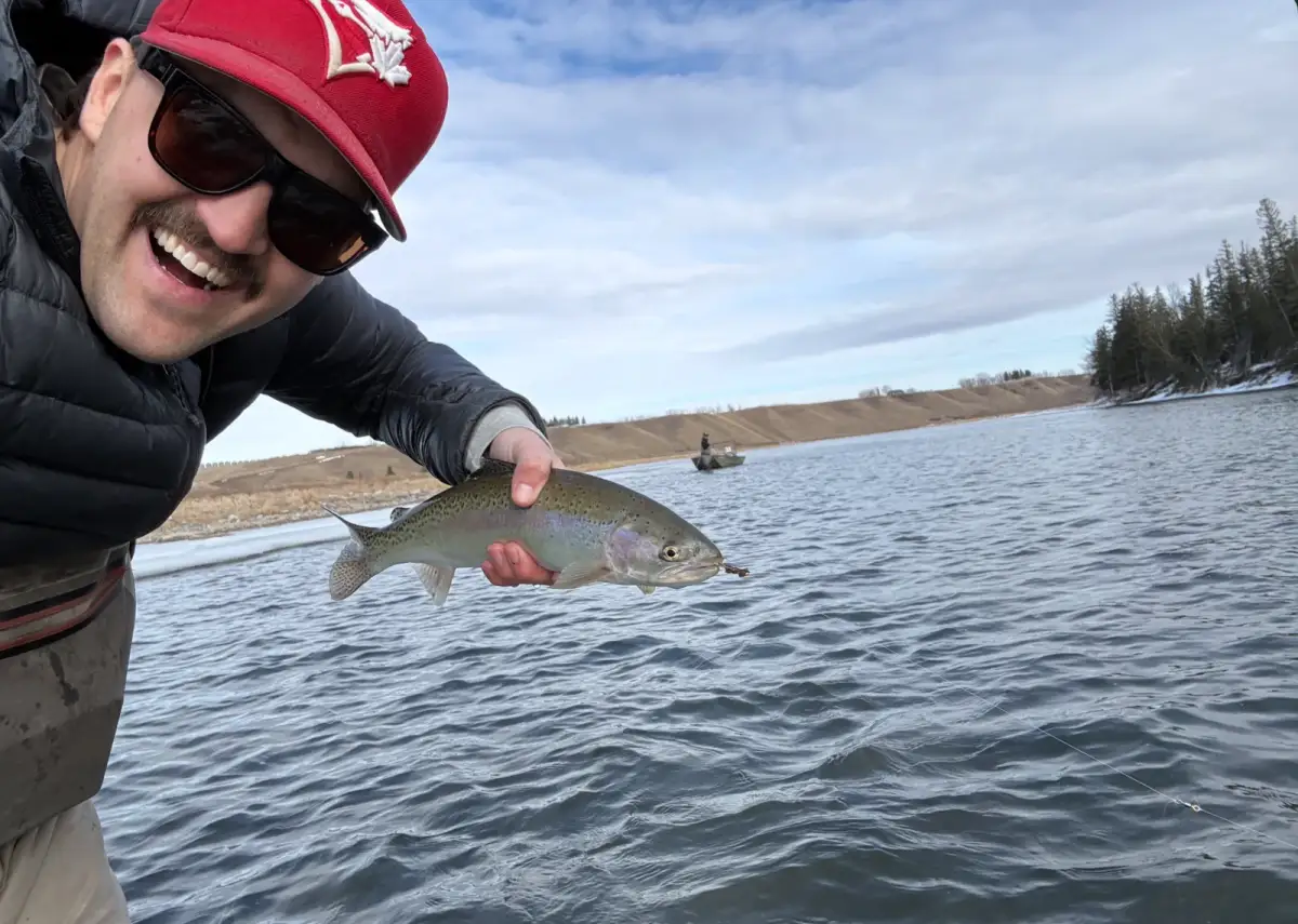 Dan King fly fishing guide displaying trophy trout caught on guided Bow River trip