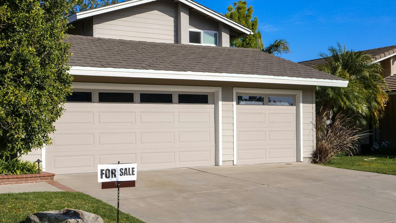 Real estate for sale sign on a residential lawn